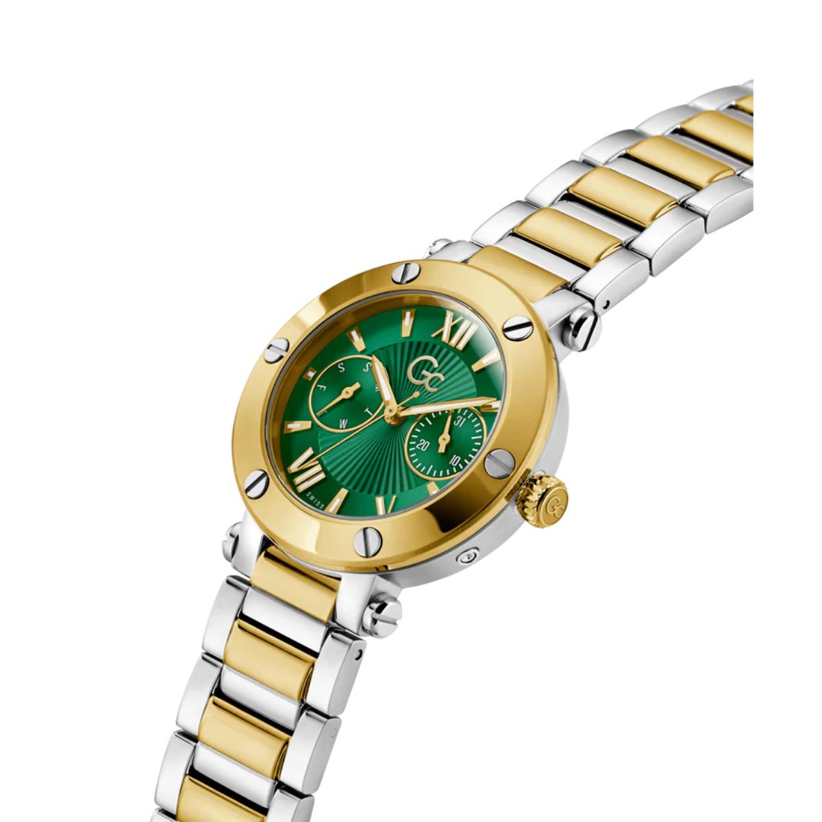 Two-tone gold and silver watch with a green face on a white background