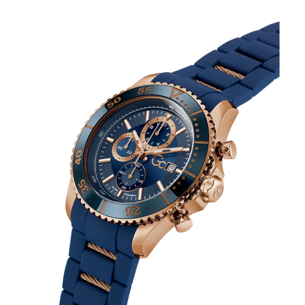 Blue watch with rose gold accents on a white background