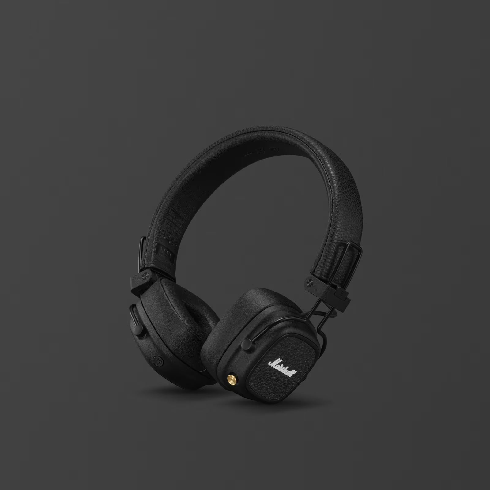 Black headphones with Marshall logo on a dark gray background