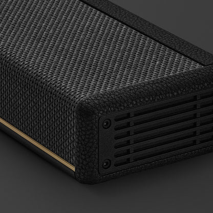 Black textured rectangular object with a ribbed surface on a dark background