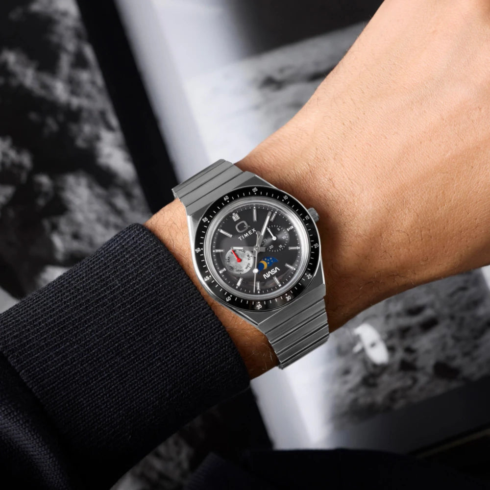 Close-up of a person wearing a Hublot watch with a blurred background