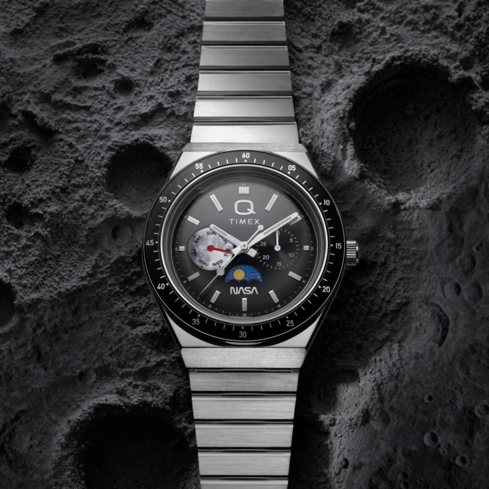 Timex watch with NASA logo on a textured dark surface