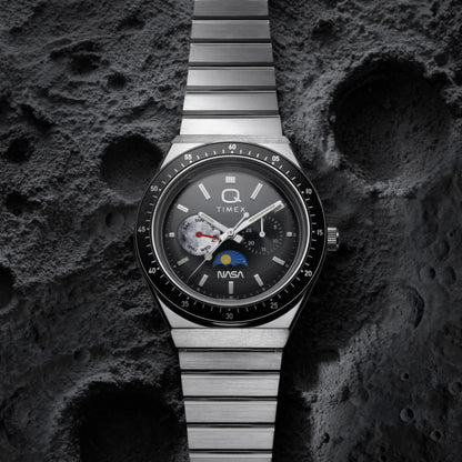Timex watch with NASA logo on a textured dark surface