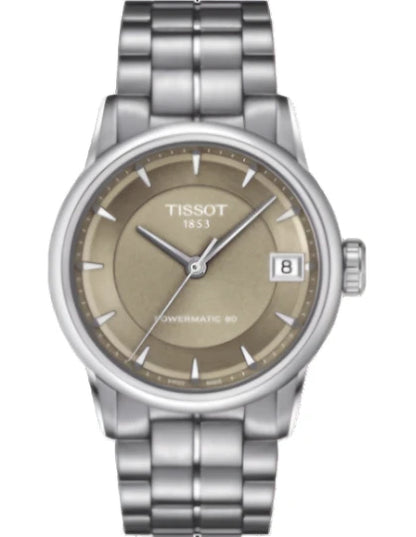 A TISSOT women's analog watch with a brown dial, stainless steel case, and a grey stainless steel bracelet.