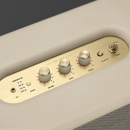 Control panel with knobs and switches on a beige surface